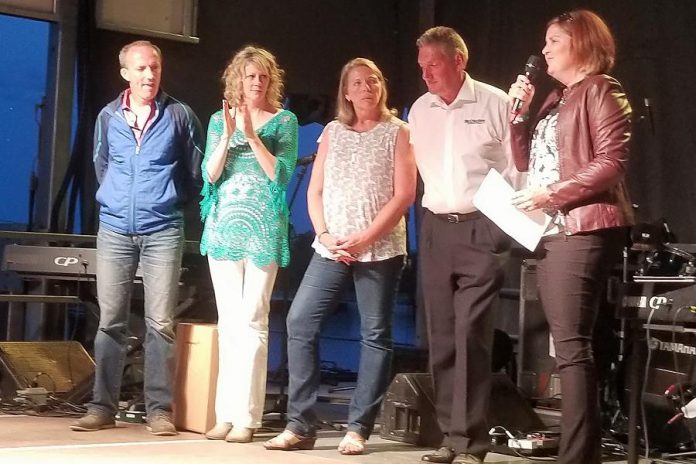 Lesley Heighway (right), President and CEO of the Peterborough Regional Health Centre Foundation, announcing the pledge of $1 million by Paschal and Sylvia McCloskey of McCloskey International (second and third from right) at the inaugural Greenbridge Celtic Folk Fest on August 25th as festival organizers and musicians Donnell Leahy and Natalie MacMaster look on. The pledge will support babies and children's programs at Peterborough Regional Health Centre. (Photo: PRHC Foundation)