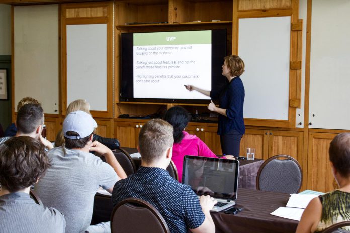 Madeleine Hurrell, Starter Company Plus Program Coordinator at the Peterborough & the Kawarthas Business Advisory Centre, shares information with Starter Company Plus participants at a summer workshop.