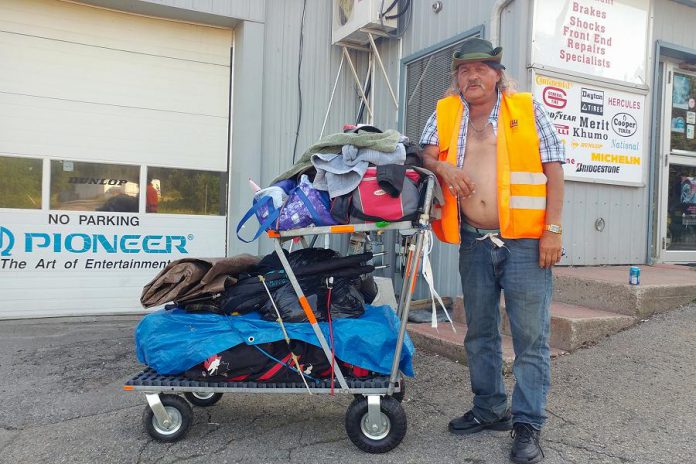 Sutherland and the cart he has pushing with his belongings as he walks to Halifax. (Photo: Daniel Scott / Facebook)
