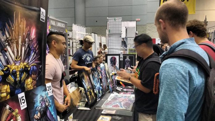 Comic book artist Kevin Briones meets fans at the Toronto Fan Expo earlier this month. He draws comics on the side, when he isn't working at his day job as a designer at Maple Leaf Sports & Entertainment in Toronto or taking care of his daughter. You can meet Kevin at the Peterborough Comic Con at the Evinrude Centre on September 24, 2017. (Photo: Sam Tweedle / kawarthaNOW)