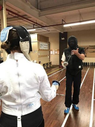 kawarthaNOW writer Paula Kehoe gets a lesson from Head Coach Scott Nichols on the basic commands, moves, and positions while fencing-a subtle sport that emphasizes etiquette and technique. (Photo: Peterborough Multi-Sport