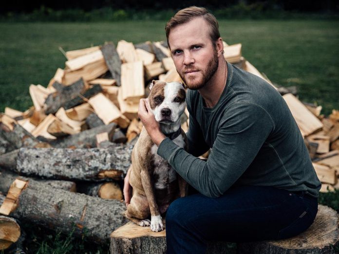 Retired NHLer Bryan Bickell poses with his rescue dog Bailey in a photo for 'Shelter Shots', the Peterborough Humane Society's fundraising calendar. (Photo: Peter Nguyen)