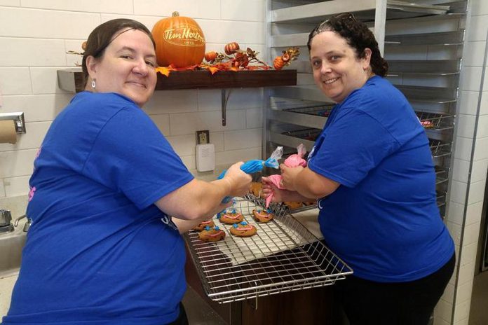 Peterborough YMCA staff helping prepare Smile Cookies at Tim Hortons in Lakefield. The $1 cookies are available from September 11 to 17 at Tim Hortons restaurants in Peterborough, Bridgenorth, and Lakefield with all proceeds going to support the YMCA Strong Kids campaign. (Photo: YMCA of Peterborough / Twitter)