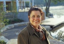 Jeannine Taylor, owner and publisher of online publisher kawarthaNOW.com, has been recognized for her community involvement, including a civic award for chairing a fundraising committee for the development of Millennium Park, pictured in the background. (Photo: Michael Cullen)