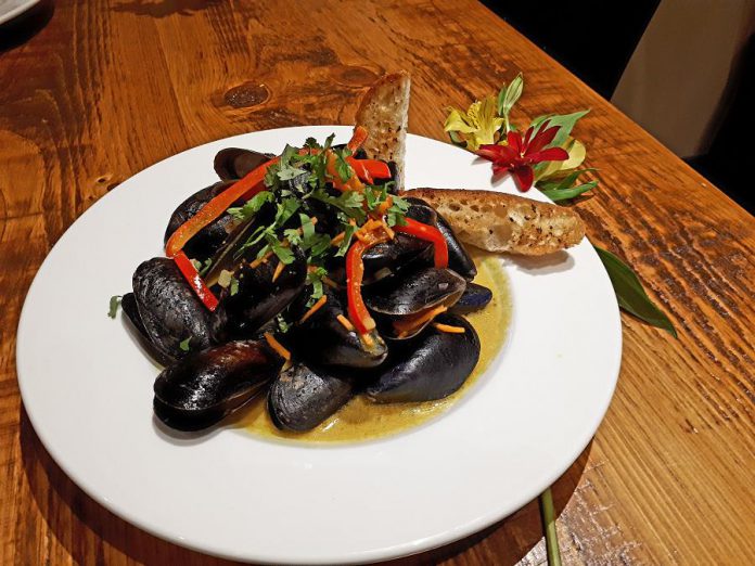 Moody's Thai Coconut and Peanut Mussels with cilantro and red bell pepper. (Photo: Moody's Bar and Grill)