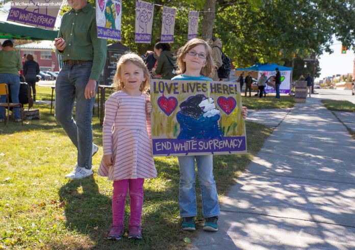 Two children with their "Love Lives Here!" sign at the Solidarity Weekend 2017 on Saturday, September 30, 2017 in Peterborough. Families participated in collective art-making with positive messages of resistance to racism and intolerance. (Photo: Linda McIlwain / kawarthaNOW.com)