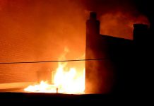 Fire emerges from the roof of a George Street building in downtown Peterborough late on Thursday evening, November 16. (Photo: Sean Bruce)