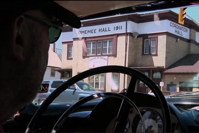 Musician Neil Young driving by Coronation Hall in Omemee, Ontario during filming of the 2011 documentary "Journeys" directed by Jonathan Demme. It's looking more and more likely that the "Somewhere In Canada" concert will take place on December 1, 2017 at Coronation Hall in Omemee, where Young spent his formative childhood years. (Photo: Sony Pictures)