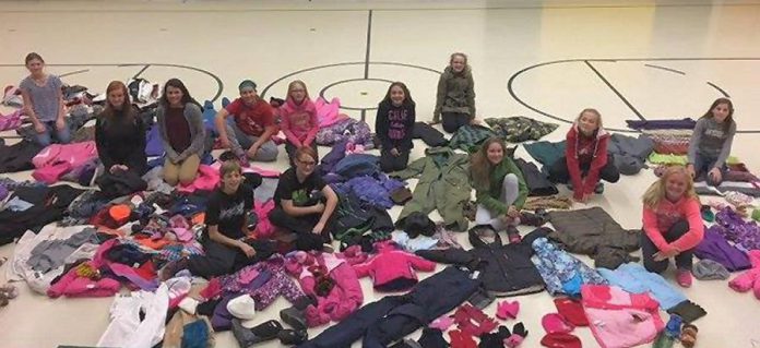 Students from St. John Catholic Elementary School in Peterborough with the coats they collected for the 2016 Northern First Nation Coat Drive. (Photo: Kawartha Truth and Reconciliation Support Group)