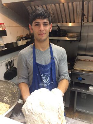 Omar Hattab, who has been living in Peterborough since October 2016, hard at work at Two Dishes restaurant in downtown Peterborough. Omar was just 12 years old when war broke out in Syria and his father and brother were killed.  Instead of going to school and continuing his education like most kids, Omar went to work in a bakery to help support his mother and his siblings. (Photo courtesy of New Canadians Centre)