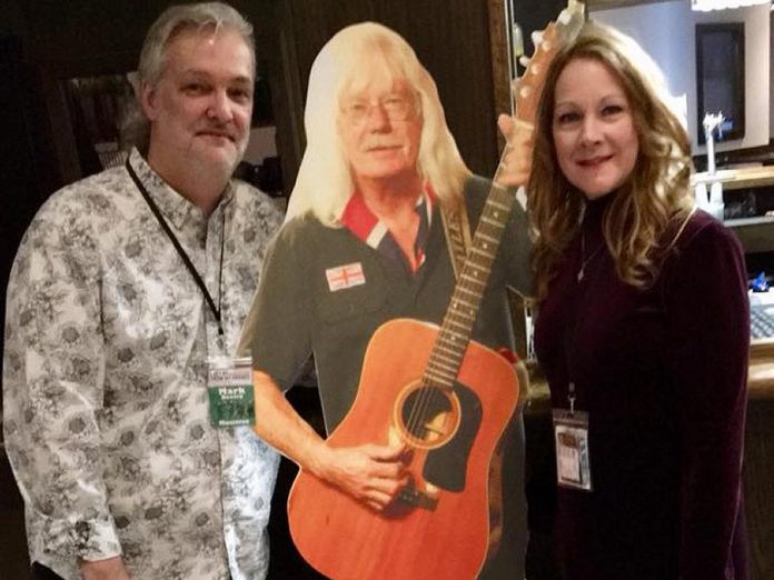 Rick Young was unable to attend the benefit, but watched the nine-hour event at home via a live stream feed set up by Sean Daniels. Attendees showed their support for Rick by taking photos with a cut-out of the much-loved musician. (Photo: Mark Beatty / Facebook)