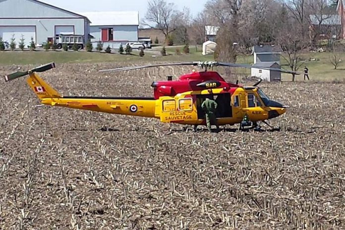 Gotta have that BBQ! This helicopter out of Canadian Forces Base Trenton landed in a farmer's field beside Muddy's Pit BBQ in Keene. (Photo: Neil Lorenzen)