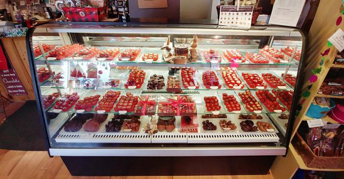 Behind a large glass counter sit hundreds of the popular signature bonbons, all handmade by Chocolatier Lois MacEachen, that carefully blend divine flavours and whimsical art. (Photo: Paula Kehoe / kawarthaNOW.com)