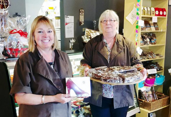 Owner Lois MacEachen (right) and her colleague Linda Anderson (left) pose with some of the items they make and design in-house. Lois is renowned for her unique designs like chocolate pizza and Linda is known for her red stiletto shoe design. (Photo: Paula Kehoe / kawarthaNOW.com)