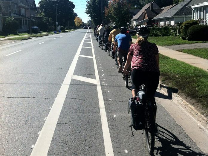 A group of cyclists using a bike lane in Peterborough. The Province of Ontario will be providing 120 municipalities (including the city and county of Peterborough, Cobourg, and Kawartha Lakes) with $93 million in funding for new bike lanes and to improve cycling infrastructure. (Photo: GreenUP)
