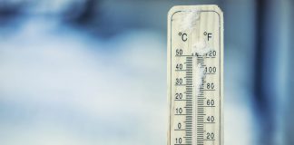 Thermometer on snow showing extreme cold temperature of 20 below zeroExtreme cold