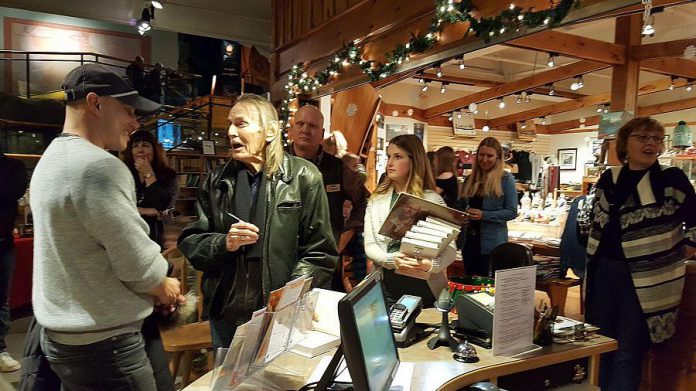 Lightfoot signing books in The Canadian Canoe Museum gift shop. (Photo: Jeannine Taylor / kawarthaNOW.com)