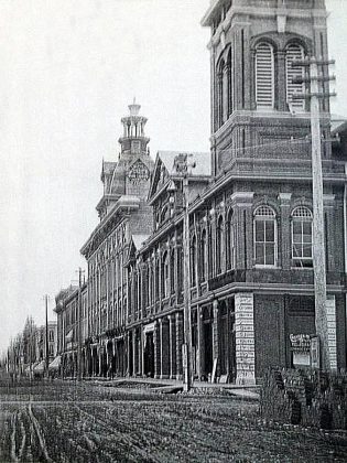 Architect John Belcher designed the large two storey brick building with an imposing four-faced clock tower. Pictured in the background is the adjoining Bradburn Opera House, which was demolished in the 1970s to make way for Peterborough Square.