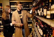 Couple buying a bottle of wine in a liquor store