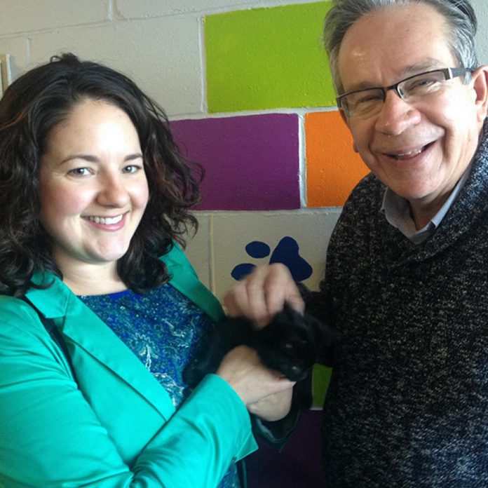 Peterborough Humane Society board member Dena Heming, Zeus the cat, and MPP Peterborough Jeff Leal at a December 20th event at the society's existing building on Lansdowne Street East. The society is launching a public fundraising campaign in early 2018 to raise $4 million for the new building. (Photo: Paul Rellinger / kawarthaNOW)