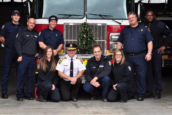Scott Lawder, Brad Luby, Mark Sullivan, Amanda Nichols, Chief Snetsinger, Ed Venuk, Jaclyn Finney, Joe Cadigan, and Patrick Wayne of the Peterborough Professional Firefighters Association, pictured in 2016. Once again this year, the association will be donating money to the annual Salvation Army Toy Drive as well as to the Salvation Army hamper fund, and will help transport the toys and distribute the hampers. (Photo courtesy of Peterborough DBIA)