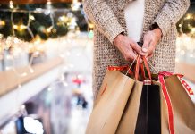 Woman on escalator with shopping bags