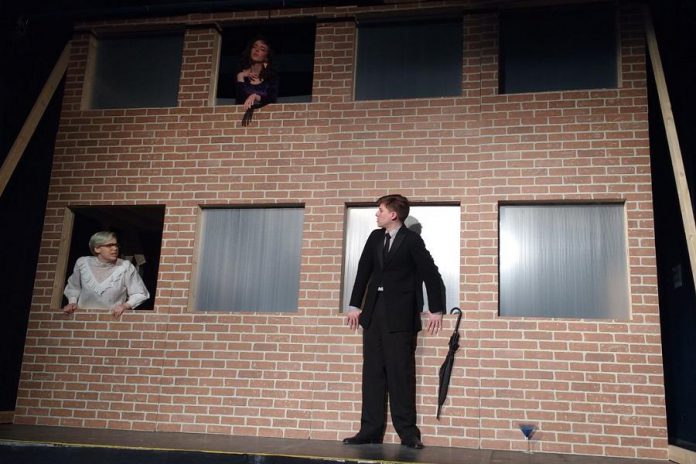 In "7 Stories", a man stands on the ledge of a building contemplating suicide while an oddball cast of characters speaks to him through apartment windows. Pictured are Kelsey Morewood as Leonard, Lori Branch as Jennifer, and Drew Mills as The Man in Anne Shirley Theatre Company's production of Morris Panych's black comedy. (Photo: Sam Tweedle / kawarthaNOW.com)