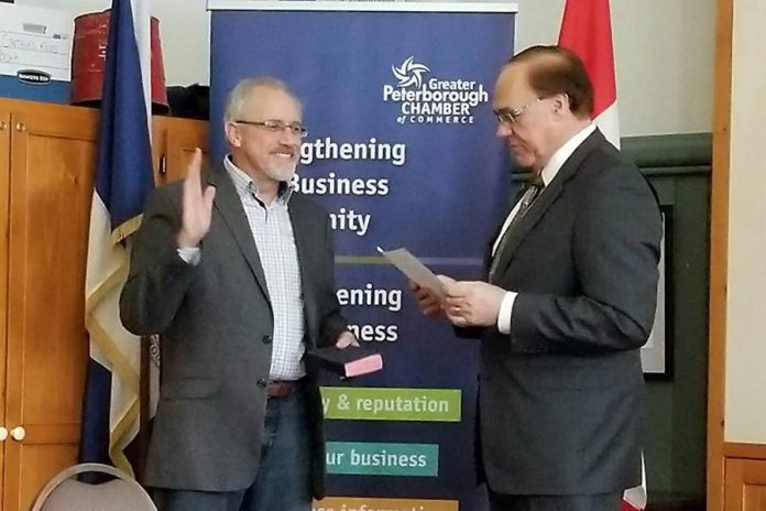 Peterborough Mayor Daryl Bennett swears in Jim Hill of James F. Hill Financial Management Services as the chair of the 2018 board of directors for the Peterborough Chamber. (Photo: Sofie Andreou)