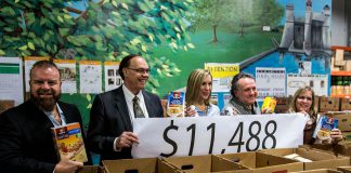 People parking in downtown Peterborough over the holidays donated $11,488 through the free parking iniative, where people can park free for two hours and any money they put in parking meters is donated to charity. Pictured are: Dan Gemmiti, Vice-Chair of the Kawartha Food Share Board; Mayor Daryl Bennett; Ashlee Aitken, General Manager of Kawartha Food Share; Terry Guiel, Executive Director of the Downtown Business Improvement Area; and Lynn Todd, Parking Operations Coordinator for the City of Peterborough. (Photo courtesy of Peterborough DBIA)