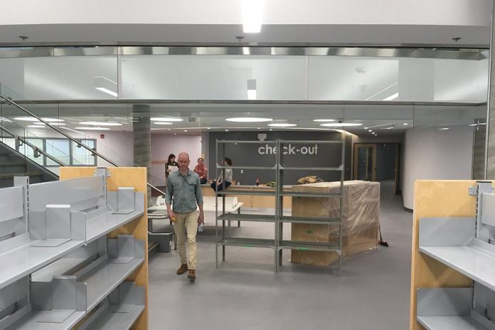 The renovated Peterborough Public Library features a new children's books area on the lower level, with a central staircase connecting to the main level. The open concept design features lots of natural light coming from the glass windows at the front of the library. (Photo: Peterborough Public Library)