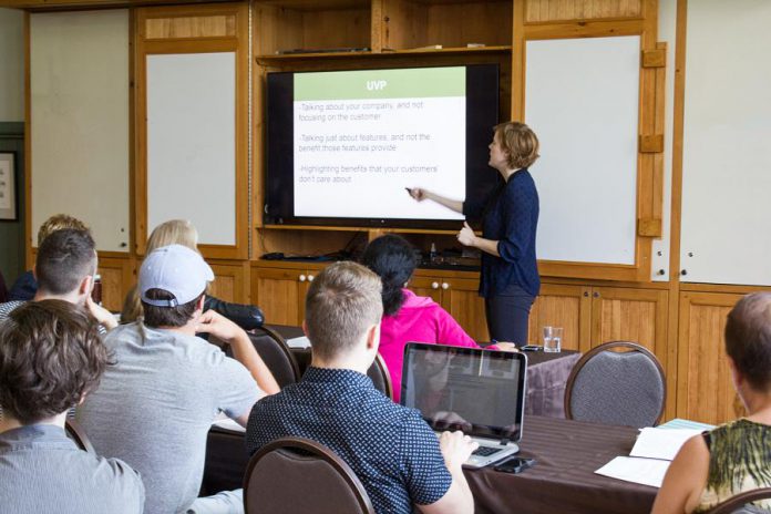 Madeleine Hurrell, Economic Development Officer who oversees the Starter Company Plus and Summer Company programs at the Peterborough & the Kawarthas Business Advisory Centre, shares information with Starter Company Plus participants at a summer workshop. (Photo: Peterborough & the Kawarthas Economic Development)