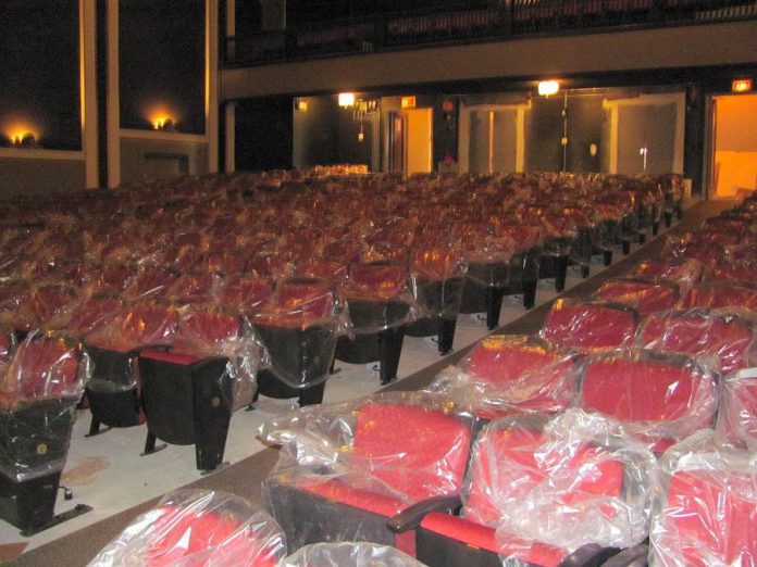 New seating installed on the main floor of the Academy Theatre in Lindsay. The new seats maintain the look of the older seats with red upholstery, dark wood, and curved backs, but are larger and more comfortable. (Photo: Academy Theatre / Facebook)