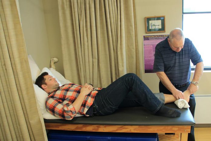 Adaptive Health Care Solutions' physiotherapists use a comprehensive treatment approach to assist you after an injury, accident, or surgery. Pictured is physiotherapist John Cook, B.Sc., P.T. treating a client.  (Photo: Adaptive Health Care Solutions)