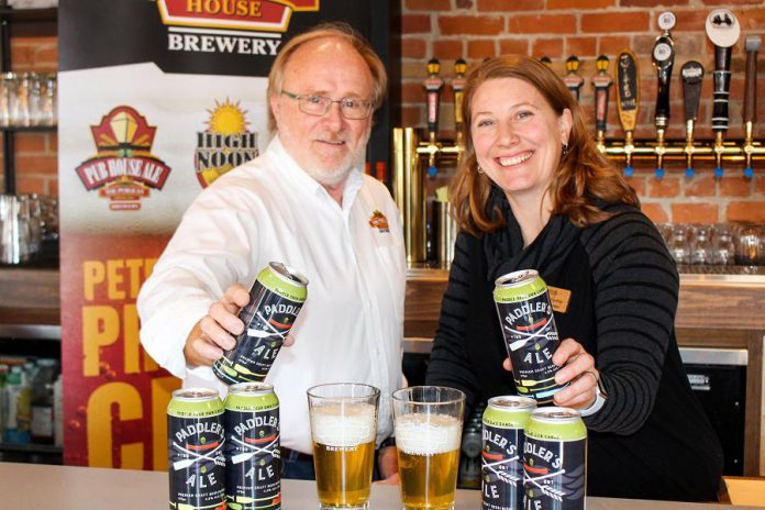 Marty Laskaris, co-founder and president of Publican House Brewery, with Carolyn Hyslop, general manager of The Canadian Canoe Museum. Publican House Brewery has raised $7,289 for the museum through sales of its Paddler's Ale. (Photo courtesy of The Canadian Canoe Museum)