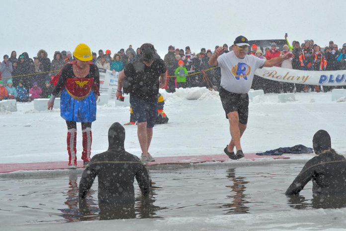 "Wonder Woman" (Andi van Koeverden, President of the Rotary Club of Peterborough), "Batman" (Trevor Copeland, President of BEL Rotary), and "Rotary Man" (Len Lifchus, President of the Rotary Club of Peterborough Kawartha) take the Polar Plunge at the annual BEL Rotary event on February 4, 2018. The event raised more than $20,000 for local charities and organizations, including $1,765 for The Warming Room in Peterborough raised through Lifchus' participation. (Photo: Lynne Chant / Rotary Club of Peterborough Kawartha)