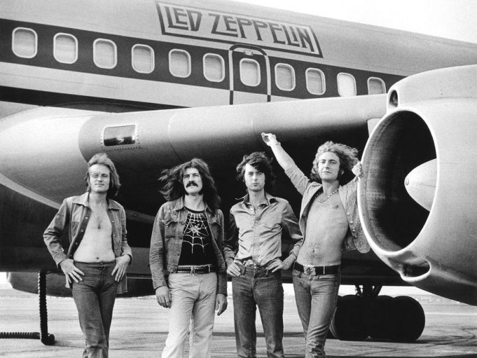 Led Zeppelin (John Paul Jones, John Bonham, Jimmy Page, and Robert Plant) in front of their private airliner The Starship in 1973. (Photo:  Bob Gruen)