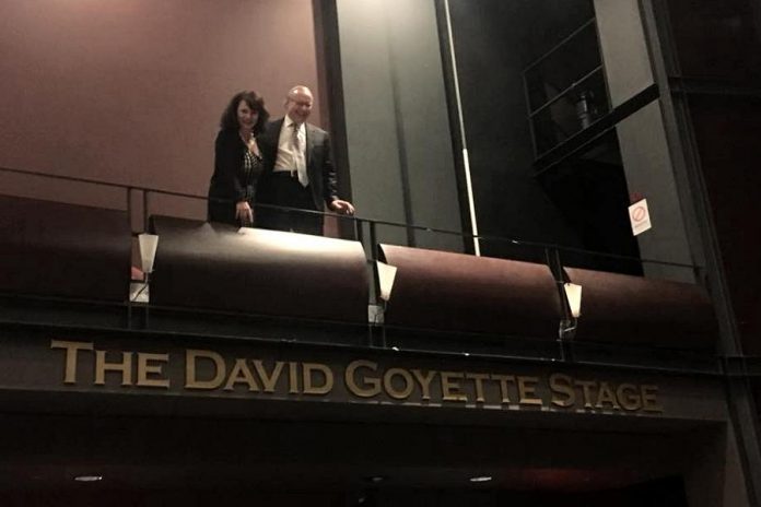 David Goyette with his wife Victoria Pearce above the sign at Showplace Performance Centre proclaiming The David Goyette Stage. Pearce and Goyatte, who already has the naming rights for the theatre's green room from an earlier donation, made a 10-year financial contribution non-profit performance venue to secure the naming rights for the stage located in the main theatre, allowing the non-profit venue to purchase a new lighting console. (Photo: Showplace Performance Centre)