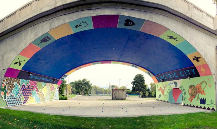 The City of Peterborough's Public Art Program is seeking Indigenous artists to create a new public artwork for Millennium Park to acknowledge Nogojiwanong on the traditional territory of the Michi Saagiig people. Pictured is a mural under the Hunter Street bridge in Peterborough by Toronto artist Kirsten McCrea that includes 'Nogojiwanong', the Anishinaabe name for what is now called Peterborough. (Photo: Kirsten McCrea)