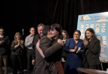 Nadine McCallen receives a hug after winning the 2018 Win This Space entrepreneurial competition at The Venue in downtown Peterborough on March 1, 2018. McCallen receives a grand prize package valued at more than $45,000 that includes a free year-long lease for a downtown Peterborough storefront. (Photo courtesy of Peterborough DBIA)