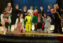 The cast of Enter Stage Right's original production "After the Battle", which runs from April 25 to 28 at the PCVS Auditorium in Peterborough. From left to right, back to front: Taite Cullen as The Wave, Isaac Martin as The Bureaucrat, Britney Burton as Madison Clark, Joel Alexander as The Guy in the Mask, Lydia Etherington as The Get It Girl, Elen Gaqollari as Masterplan, Amy Daye as Eye Candy, Ceilidh Peters, Katey Cliff, Shayne Fertile, Lena Ross as Appleonia, Antje Kroes as The Multi-Purpose Marauder, Jordan de Groot as The Gooch. and Lauren Wilson as Snitchy. (Photo: Sam Tweedle / kawarthaNOW.com)