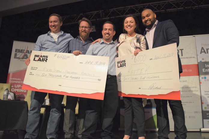 Percheron Plastic Inc. (which produces FireStraw fire starters) and virtual and augmented reality start-up Kavtek accepting their cash prize of $6,500 each at the final pitch event of the 2018 Bears' Lair Entrepreneurial Competition, held on April 18, 2018 at The Venue in downtown Peterborough. Along with the cash prize, the winners receive in-kind prizes, all donated by the 2018 Bears' Lair sponsors. (Photo courtesy of Scott Howard)