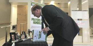 Peterborough Mayor Daryl Bennett signs the book of condolences for the Humboldt Broncos at City Hall. The book, along with a display honouring the memory of those who lost their lives, will be available at Peterborough City Hall until Friday, April 13th, and then at the Peterborough Memorial Centre until Sunday, April 22nd. (Photo courtesy of the Peterborough Petes)