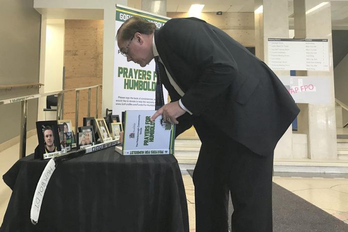 Peterborough Mayor Daryl Bennett signs the book of condolences for the Humboldt Broncos at City Hall. The book, along with a display honouring the memory of those who lost their lives, will be available at Peterborough City Hall until Friday, April 13th, and then at the Peterborough Memorial Centre until Sunday, April 22nd. (Photo courtesy of the Peterborough Petes)