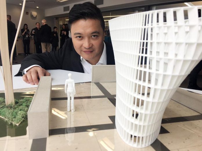 Peterborough legal firm LLF Lawyers is sponsoring the new public square beside the Peterborough Public Library in the amount of $100,000, including $20,000 for the acquisition and installation of a new public art piece. Here Toronto architect Patrick Li poses with a model of his design that was chosen for the public square. LLF Lawyers is asking for the public to vote for one of seven selected names for the new public square. (Photo: Paul Rellinger / kawarthaNOW.com)