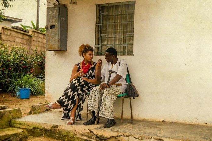 Measha visited the central African county of Cameroon, the land of her ancestors, where she was welcomed into the Bassa tribe. She collaborated with local artists while learning about modern Cameroonian culture and the past atrocities that took her ancestors from the land.  Here she speaks with Bassa spiritual leader Mbombog Mbengang Nkaïnjé.  (Photo: Rhombus Media)