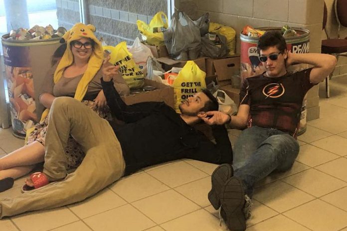 Pop Culture Canada staff relax after collecting 1,115 pounds of donated food for the local food bank at Peterborough Comic Con in September 2017. (Photo: David Wyldstar)