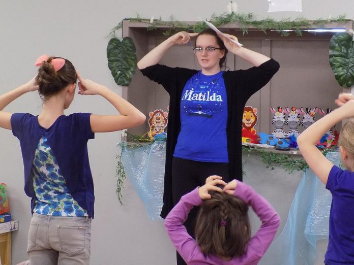 Alexis Wilson, owner of arts-based business The Tiny Talents Arts Company in Fenelon Falls, with some of her students during a musical theatre camp.  She launched her business to address a lack of local theatre and arts programs  and was accepted into the Summer Company program last year. (Photo courtesy of Alexis Wilson / The Tiny Talents Arts Company)