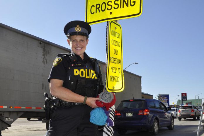 Sergeant Sandy Adams from the Bancroft OPP Detachment participated in the yarn bomb. (Photo courtesy of Knittervention)