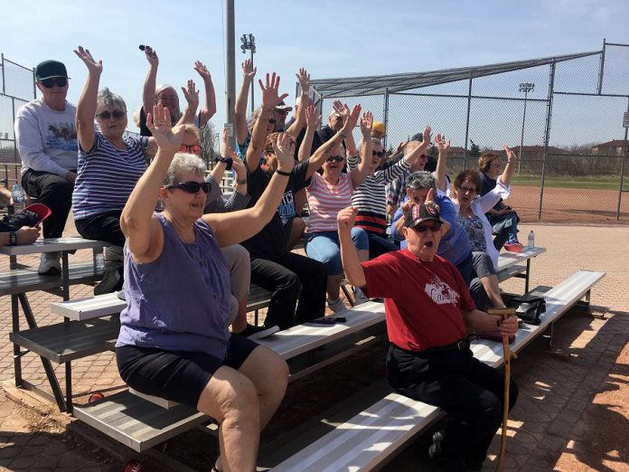 An enthusiastic crowd of supporters gathered for the slo-pitch game between J.O. Express and McMillan Sports that followed the  Bill Bowers plaque dedication Wednesday morning (May 2) at Bowers Park off Brealey Drive. (Photo: Paul Rellinger / kawarthaNOW.com)