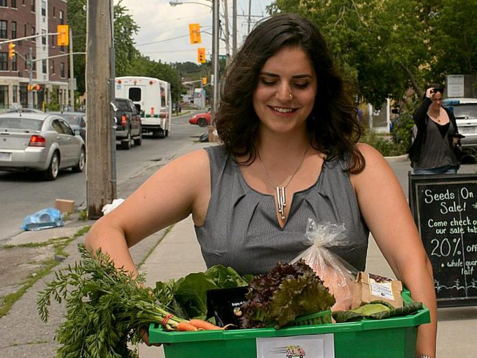 A customer picking up her order from Locavorest, an online farmers' market carrying items from more than 25 local producters. As of May 25, 2018, in addition to picking up orders, customers can now arrange for home delivery within the City of Peterborough. (Photo courtesy of Innovation Cluster)